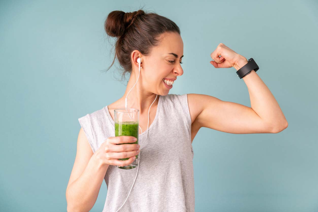 woman drinking post workout spinach smoothie