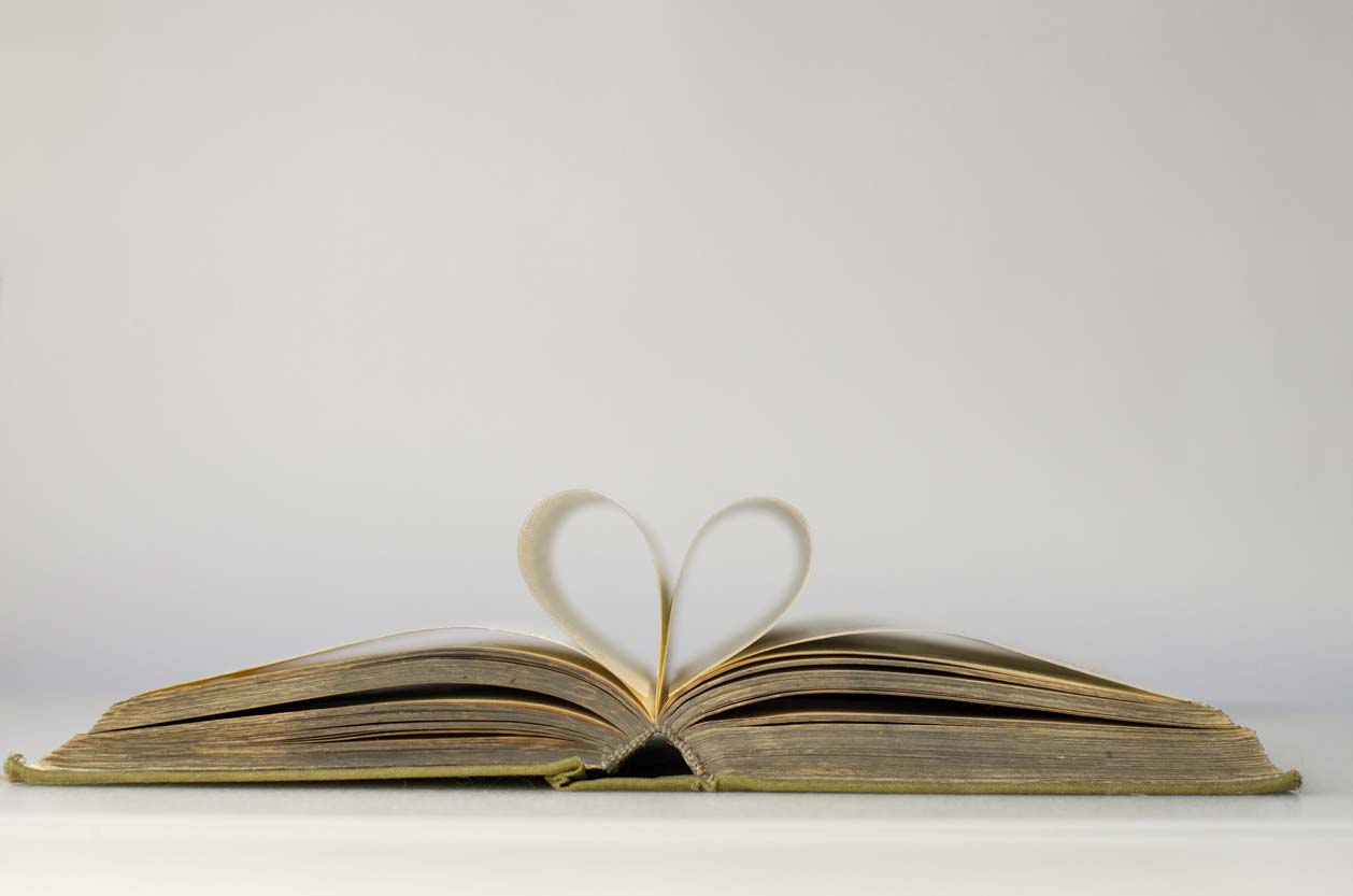 open book with pages making heart shape