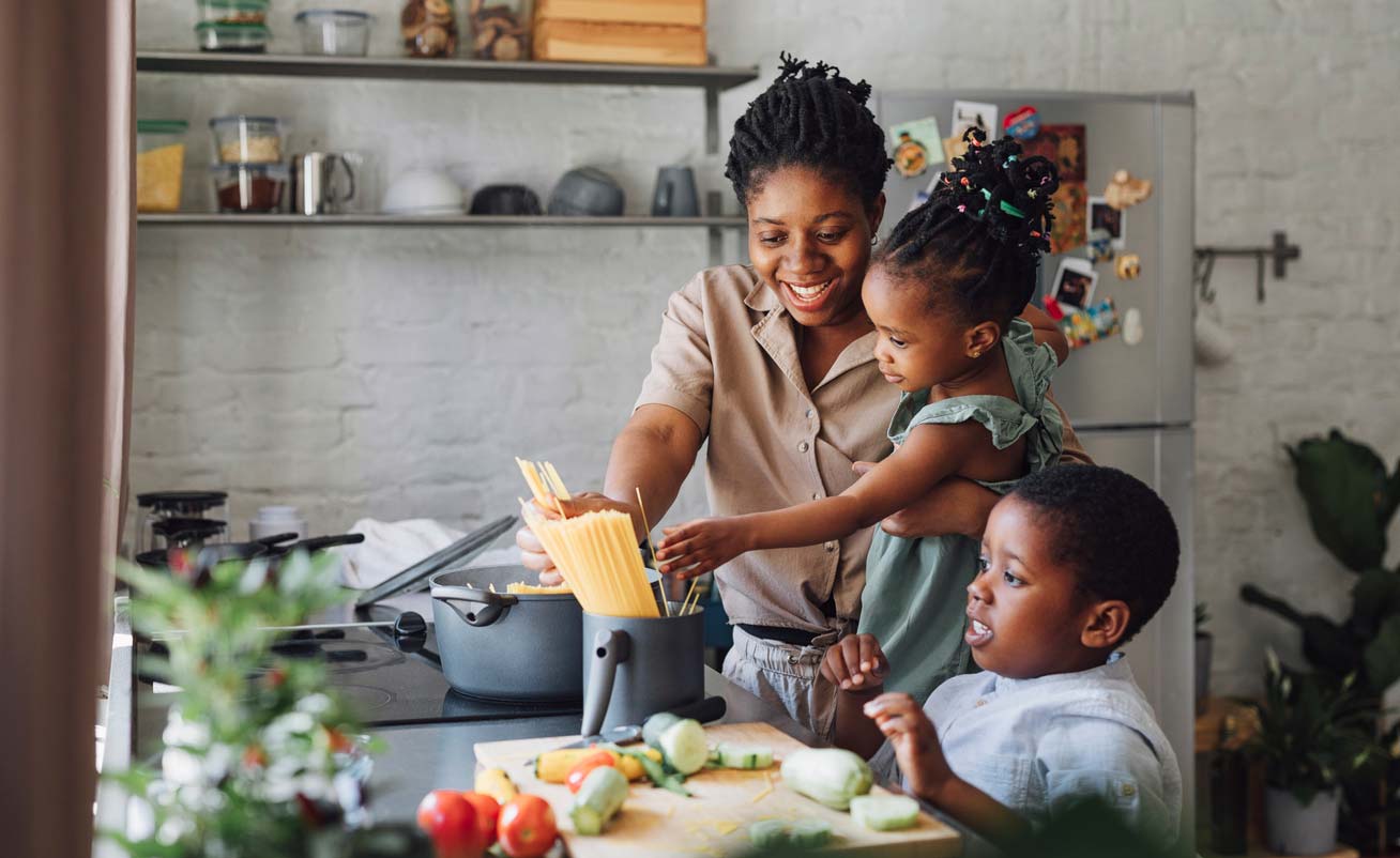 mother son and daughter prepping a spaghetti meal