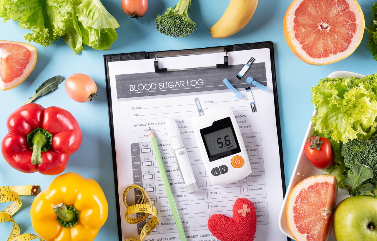 top view of healthy food in plate with stethoscope and red heart for cholesterol