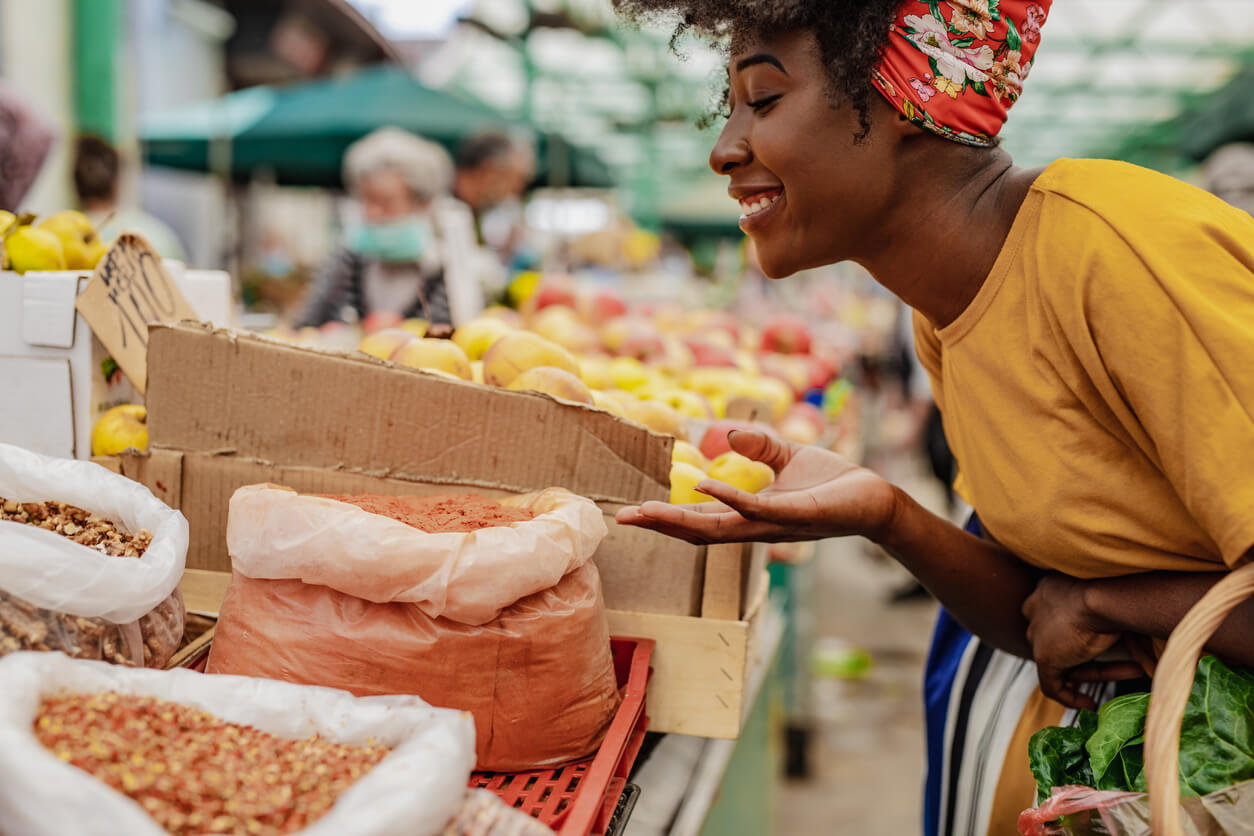 young african woman buying spices at the market