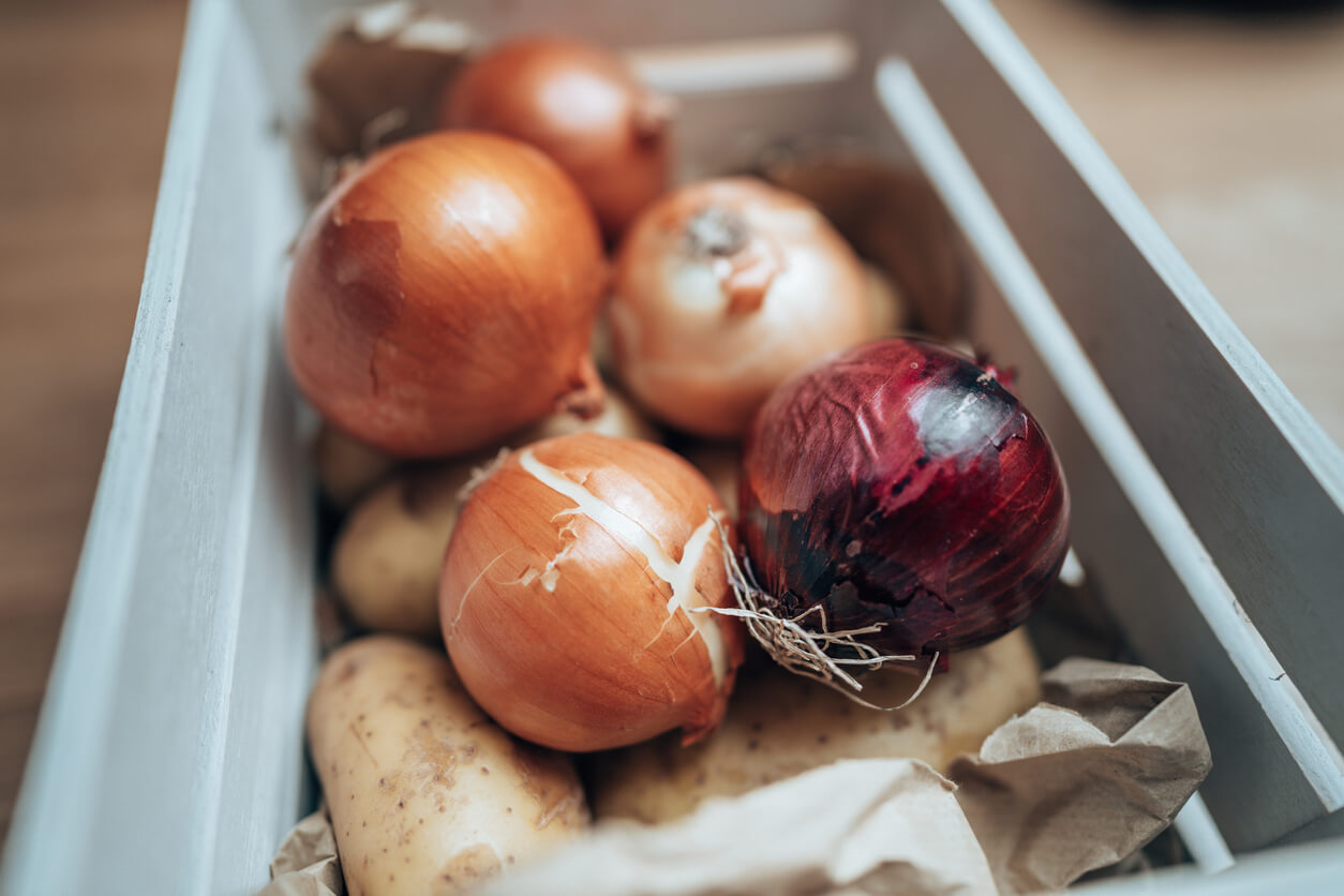 basket of onion potato and garlic