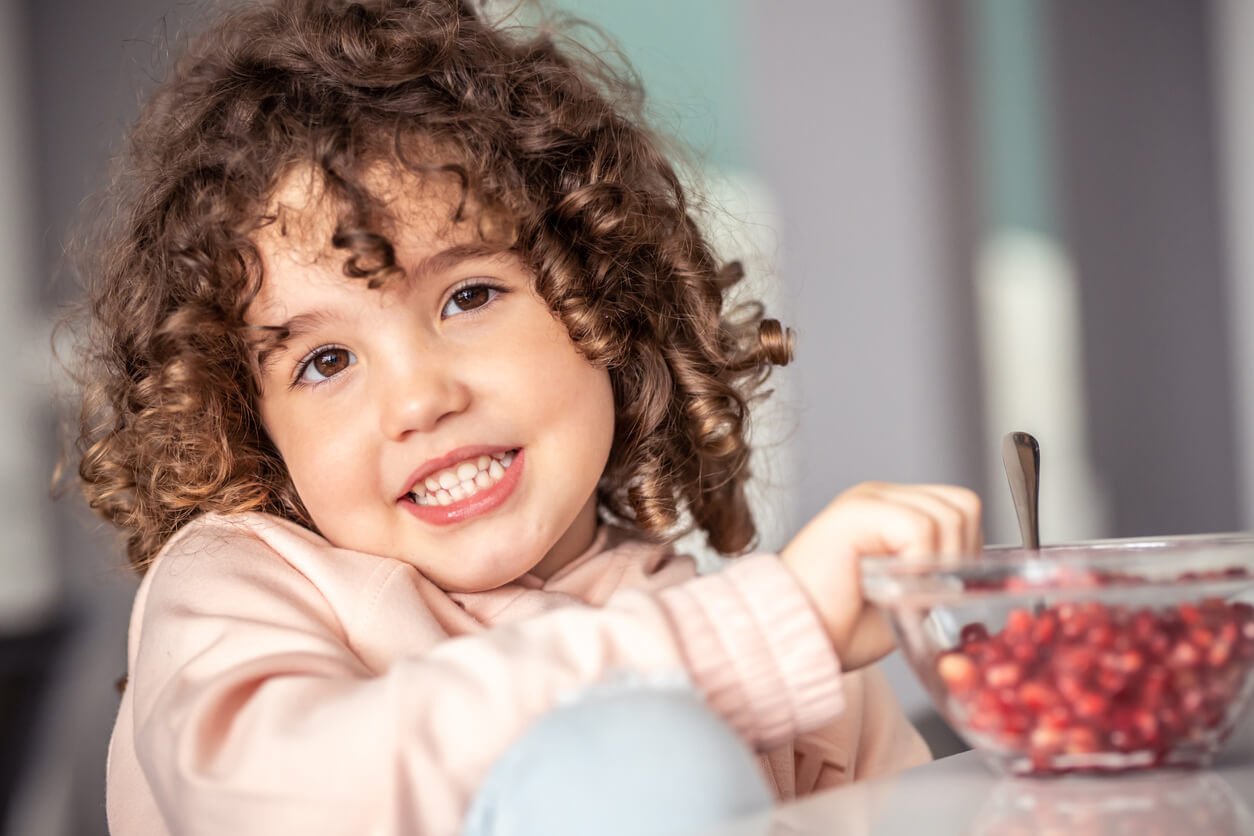 little girl eating fruit