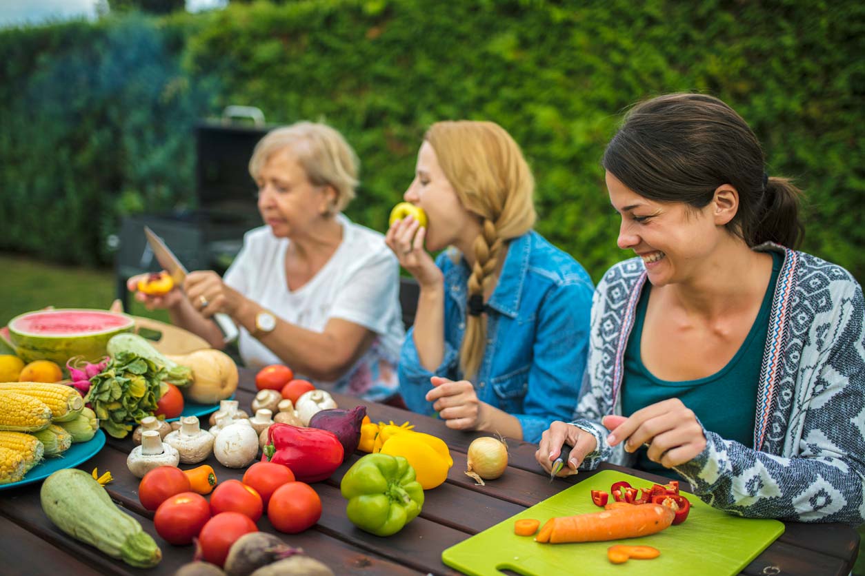 people at a vegan barbecue enjoying summer foods