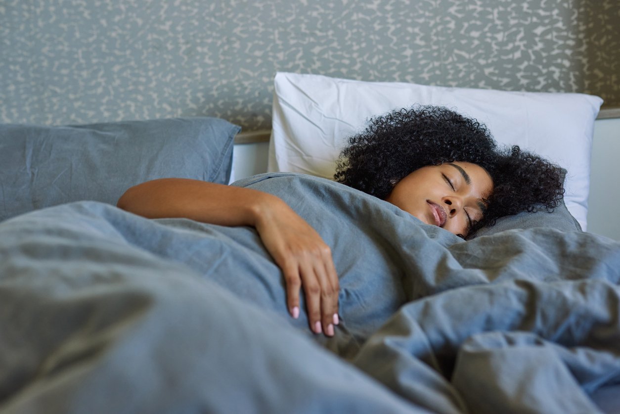 Shot of a young woman sleeping in her bed at home