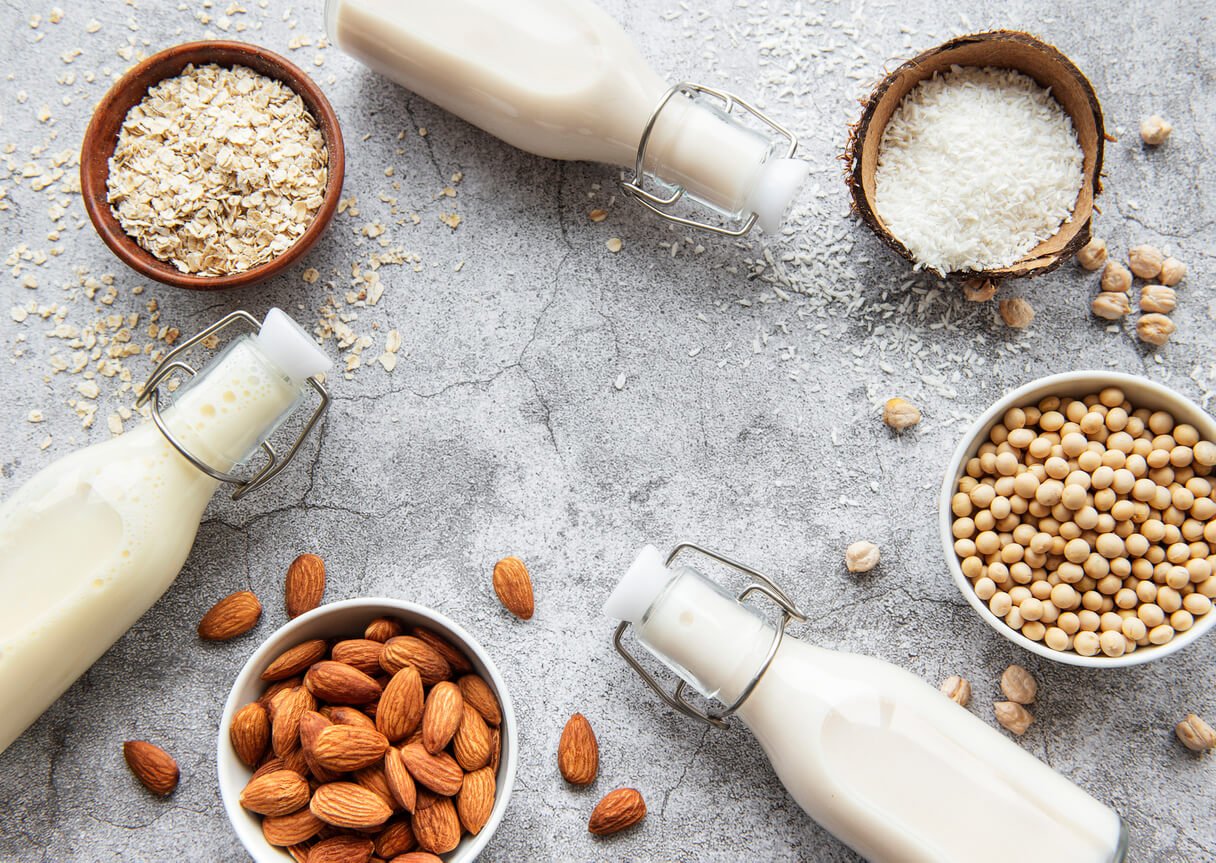 alternative types of vegan milks in glass bottles