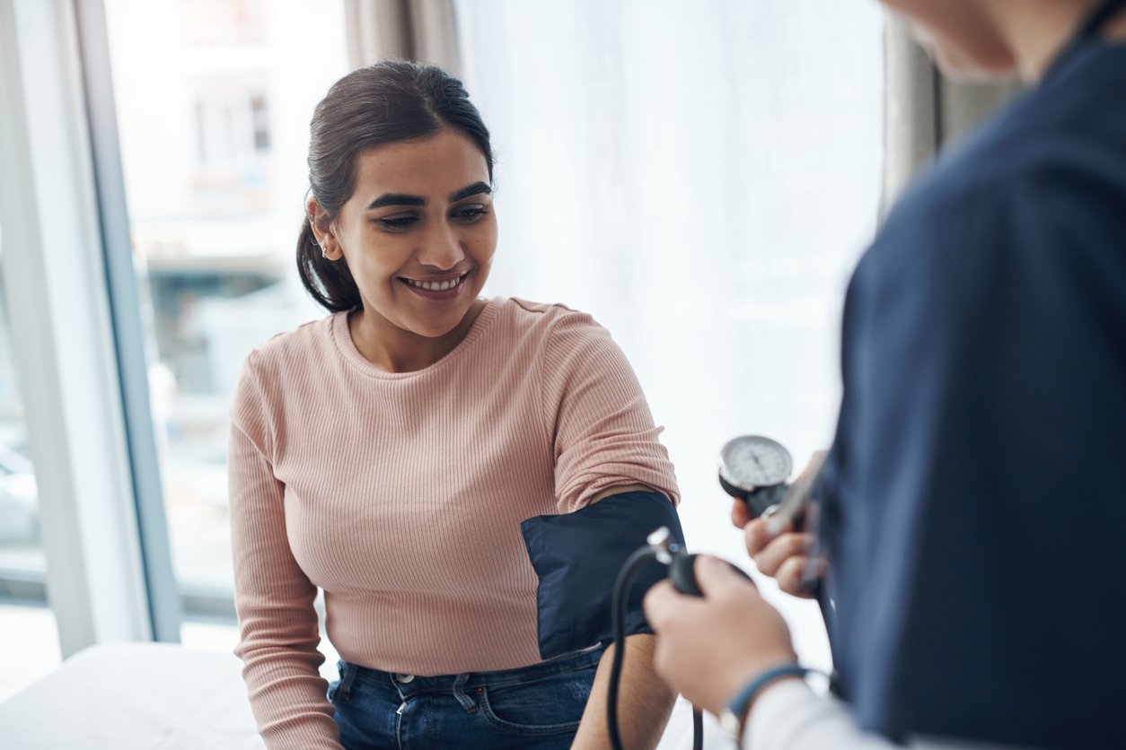 Woman of color getting her blood pressure checked