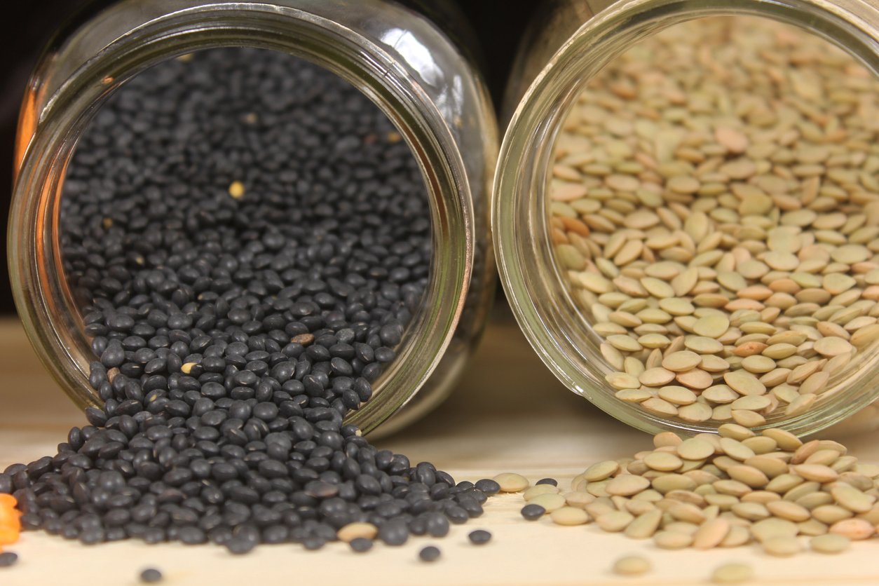 Dried Black, Green and Orange Lentils on Wooden Table