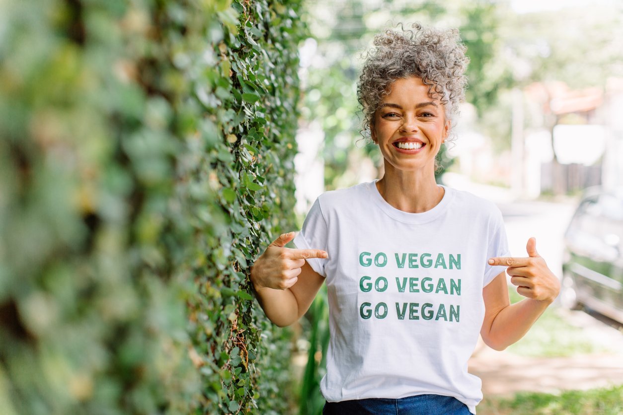 Happy vegan activist advocating for veganism outdoors