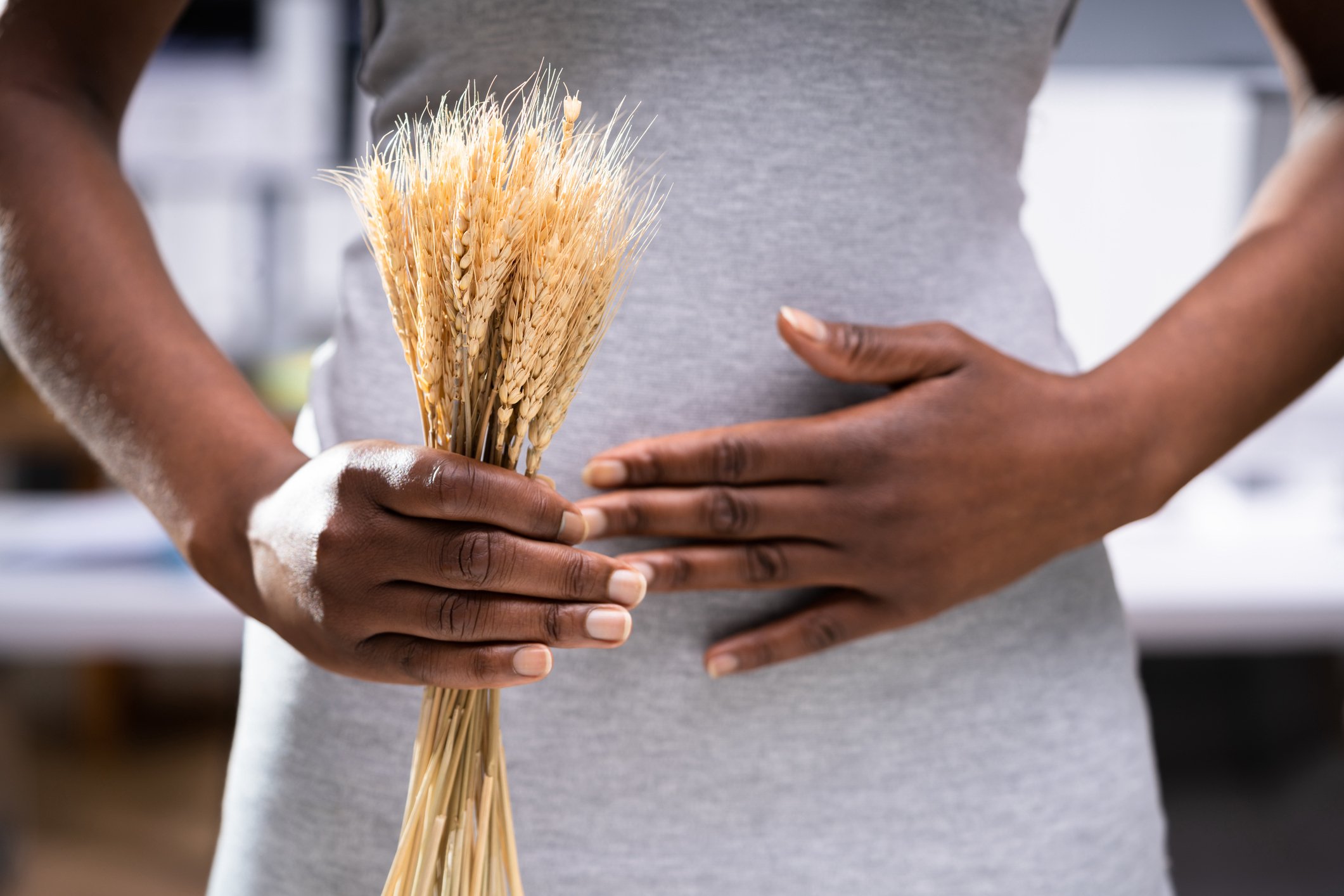 Celiac Disease And Gluten Intolerance. Women Holding Spikelet