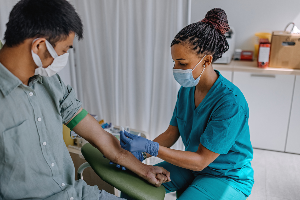 Nurse preparing patient to do a blood analysis