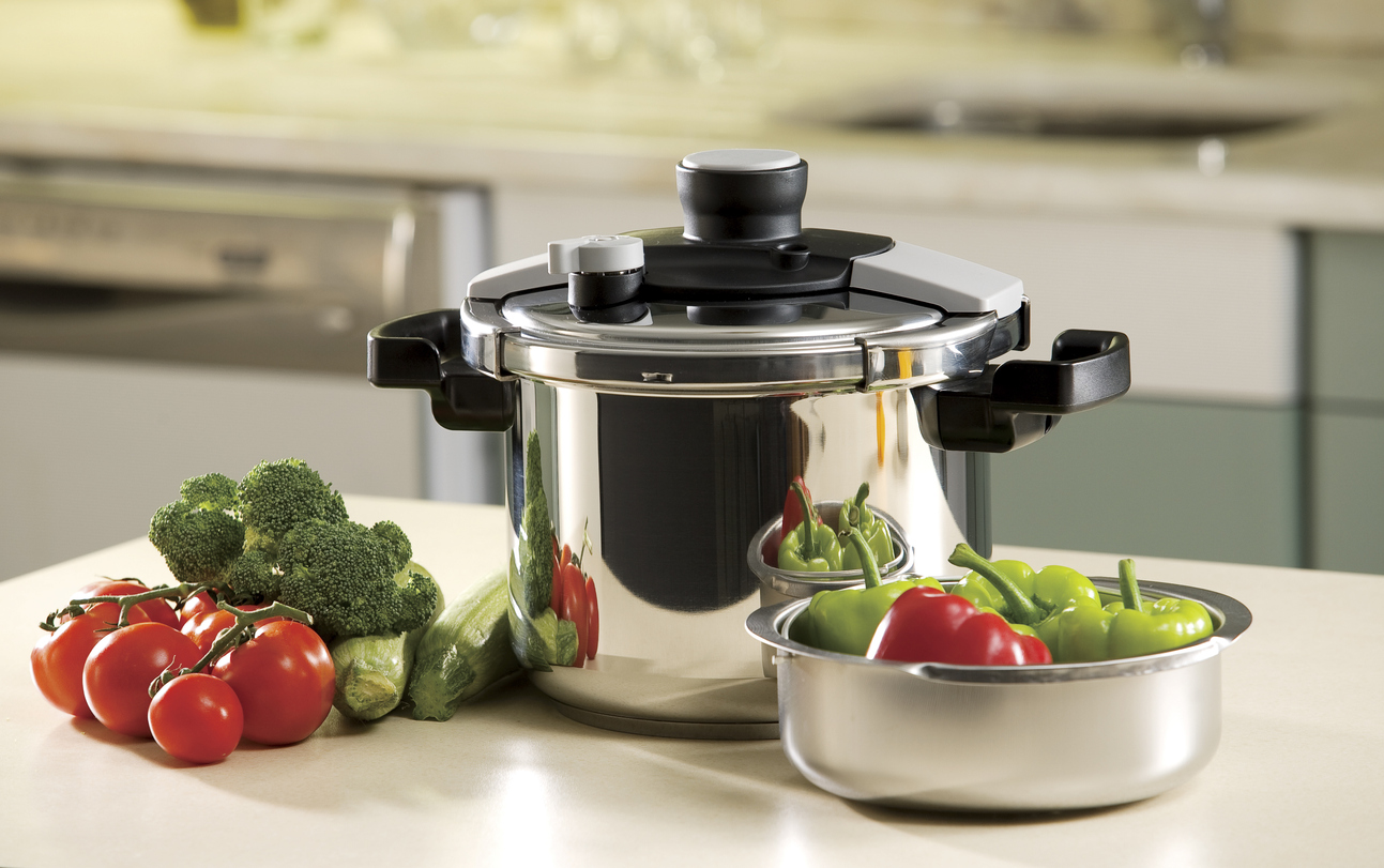 Pressure cooker and vegetables in the kitchen