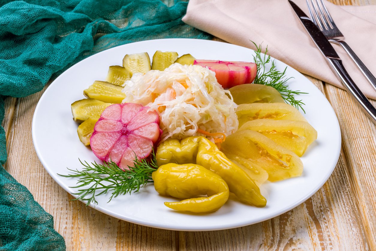 plate of pickles on white plate on wooden table