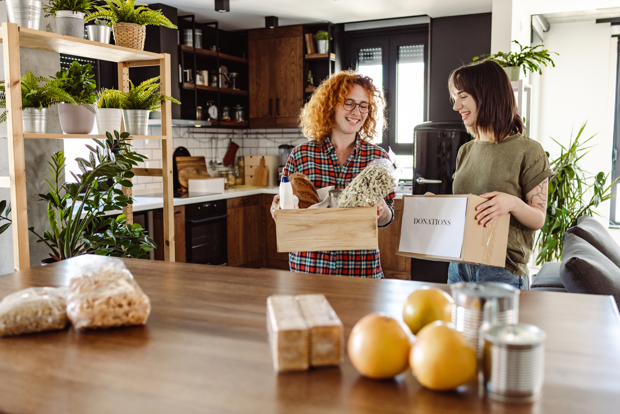 Lesbian couple prepares food donations in their kitchen