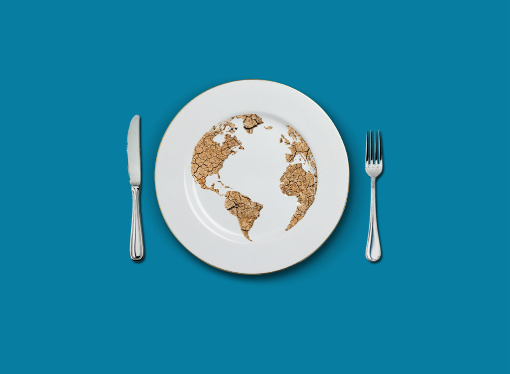 World food climate footprint concept on plate with fork and knife.