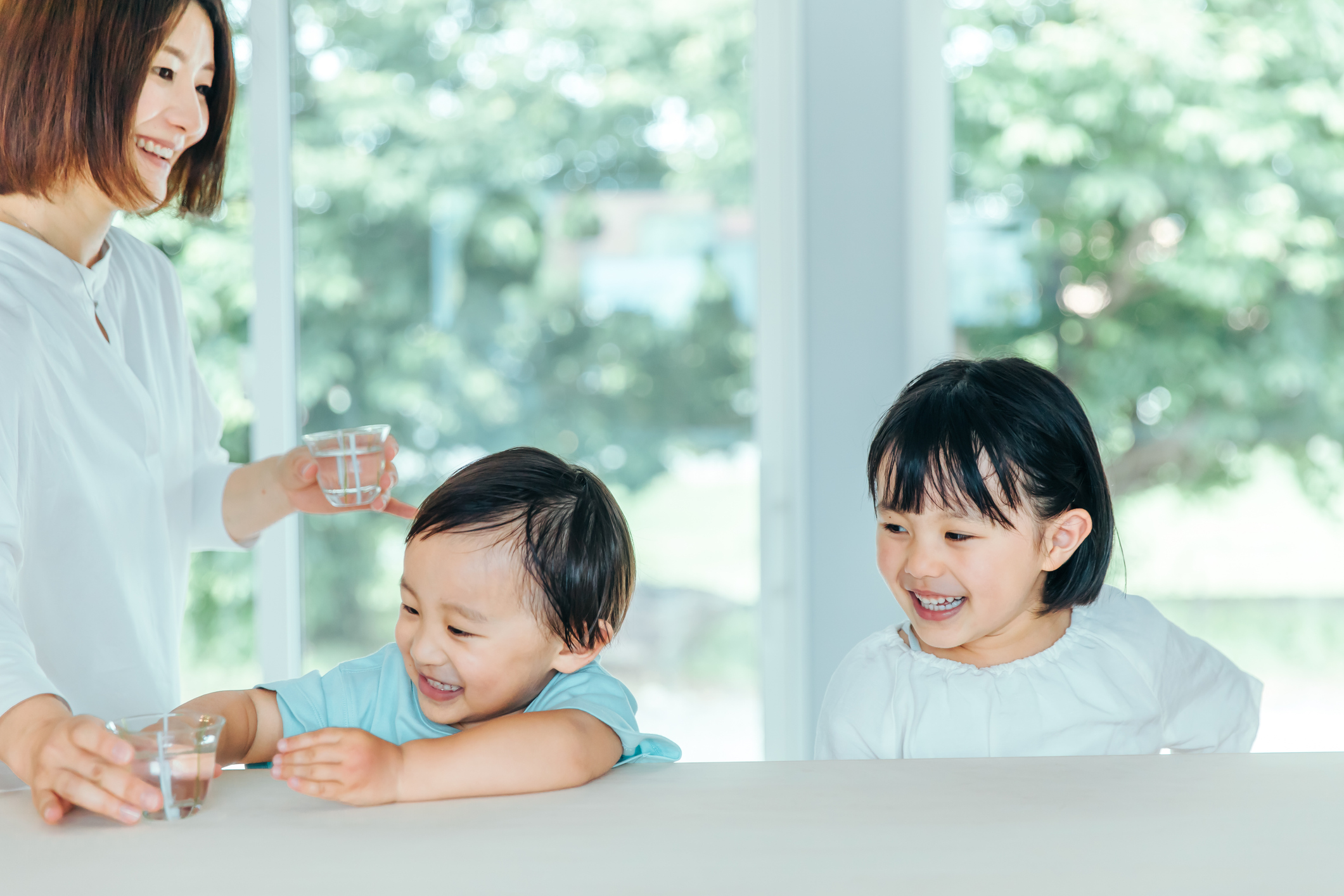 Mother and child spending time in the living room.child drinking water