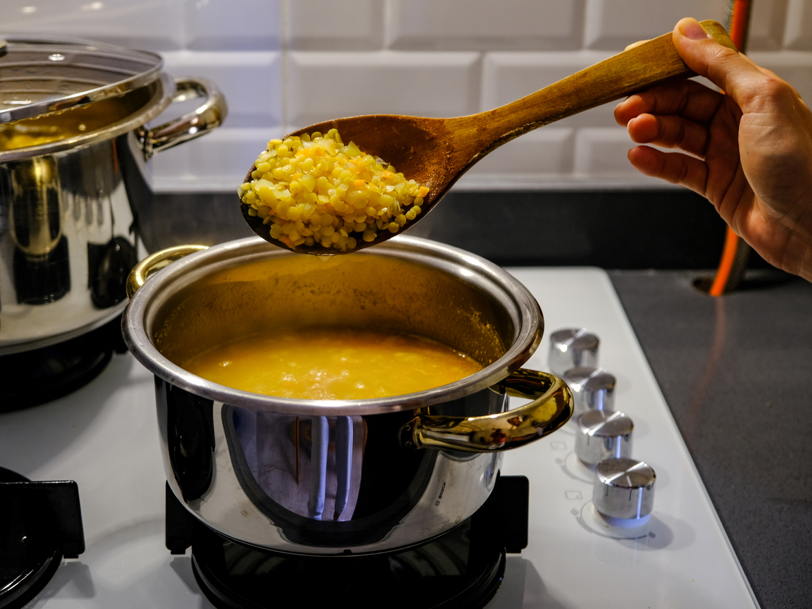 Preparing lentil soup on a stove 