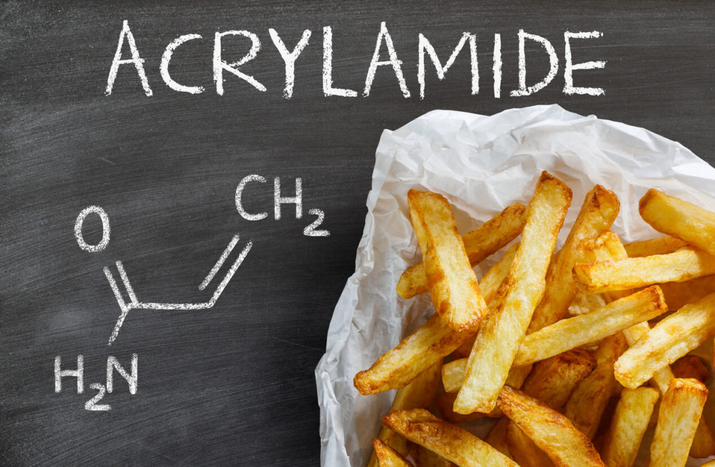 French fries displayed against a chalk board labeling acrylamide