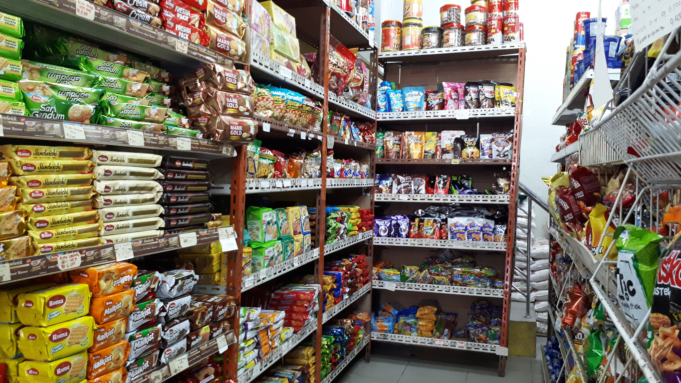 Abstract blurred supermarket aisle with colorful shelves and recognizable customers as background