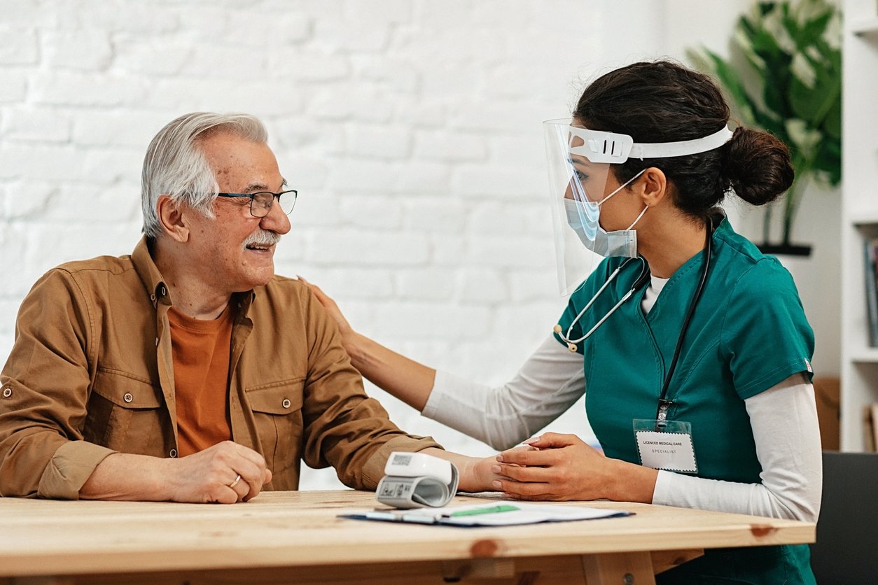 Doctor in a home visit to a senior man