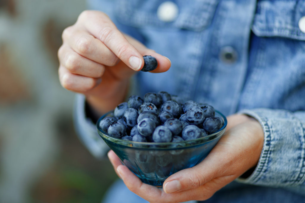 Eating blueberries out of a bowl