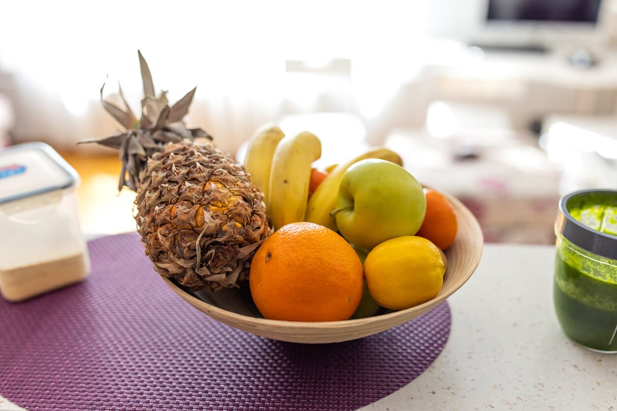 fresh fruits in a bowl on kitchen counter