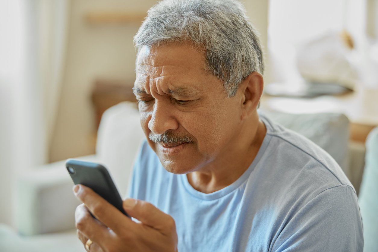 Senior man with smartphone, confused and reading message with vision problem or fail to understand app. Social media, communication and issue with technology and male person in retirement at home