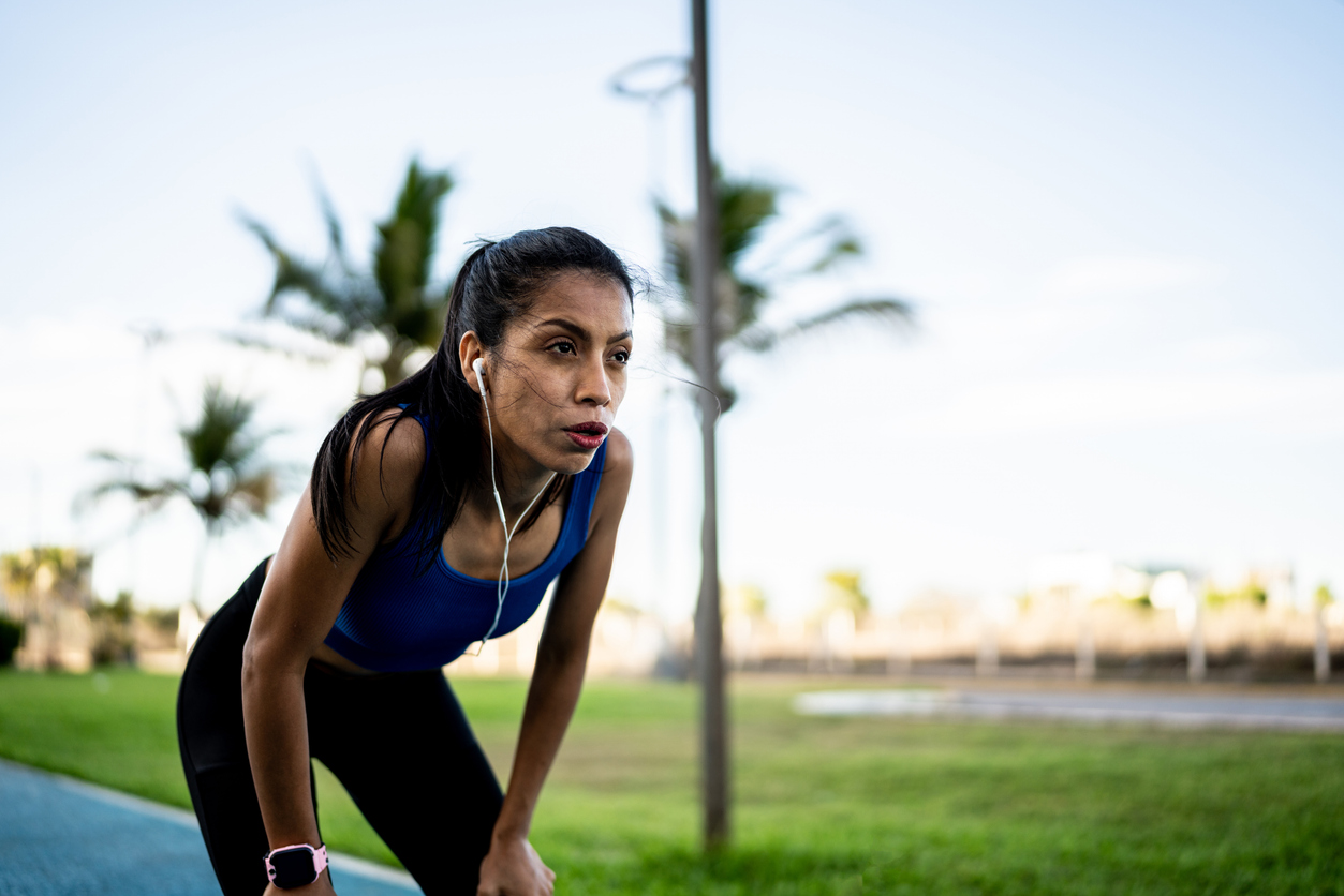 Young sporty woman tired after running outdoors