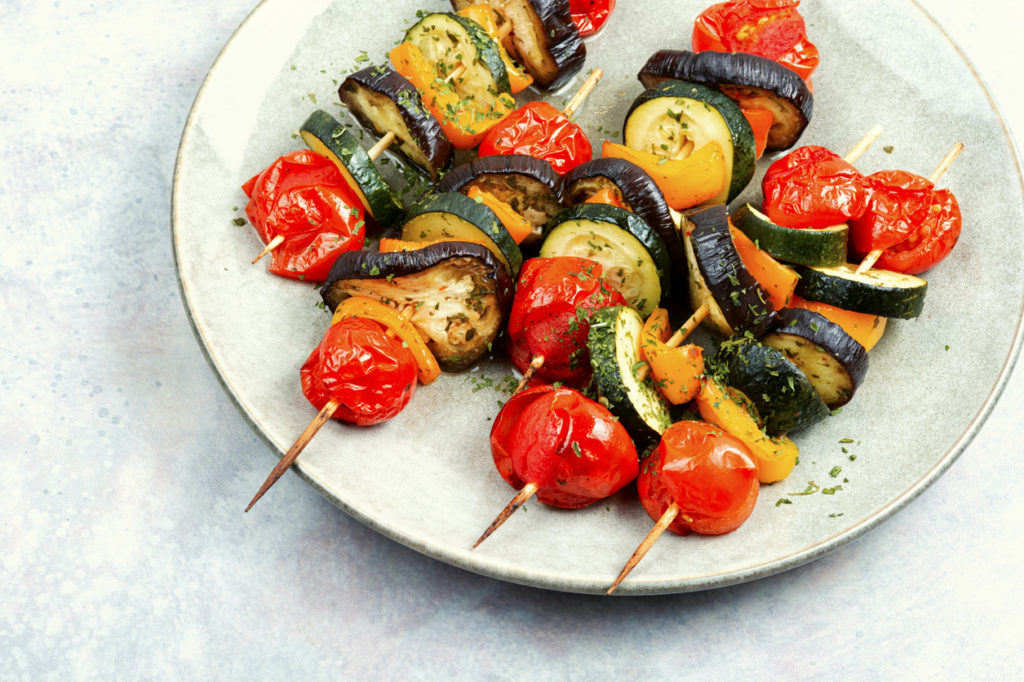 Vegetable skewers on wooden skewers. Summer barbecue.