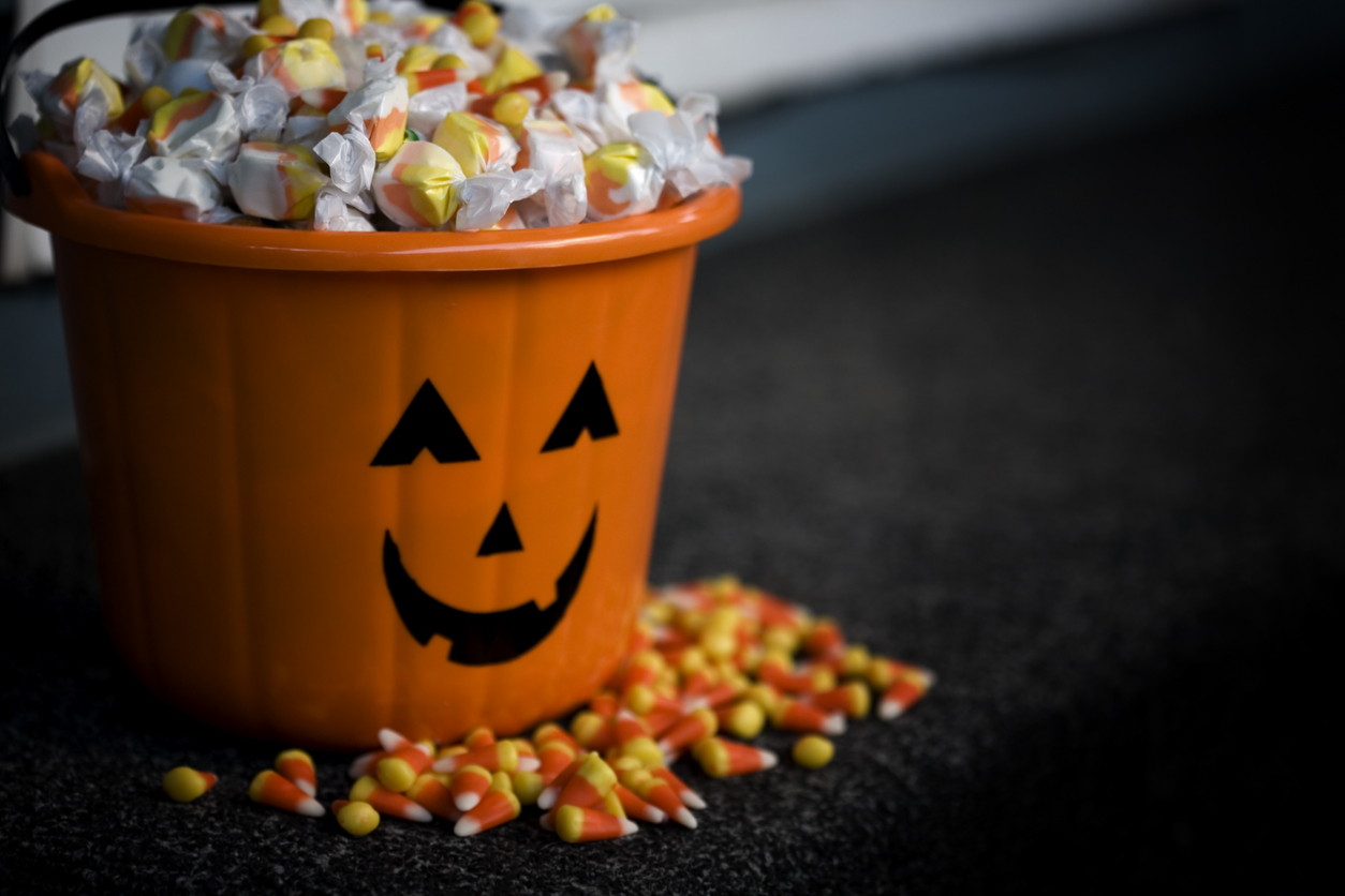 A jack o lantern bucket with Halloween candy