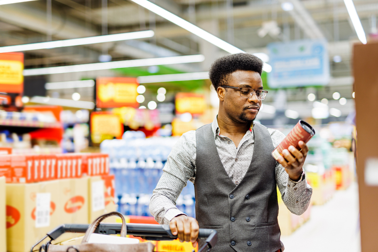 Man reads nutrition labels while shopping