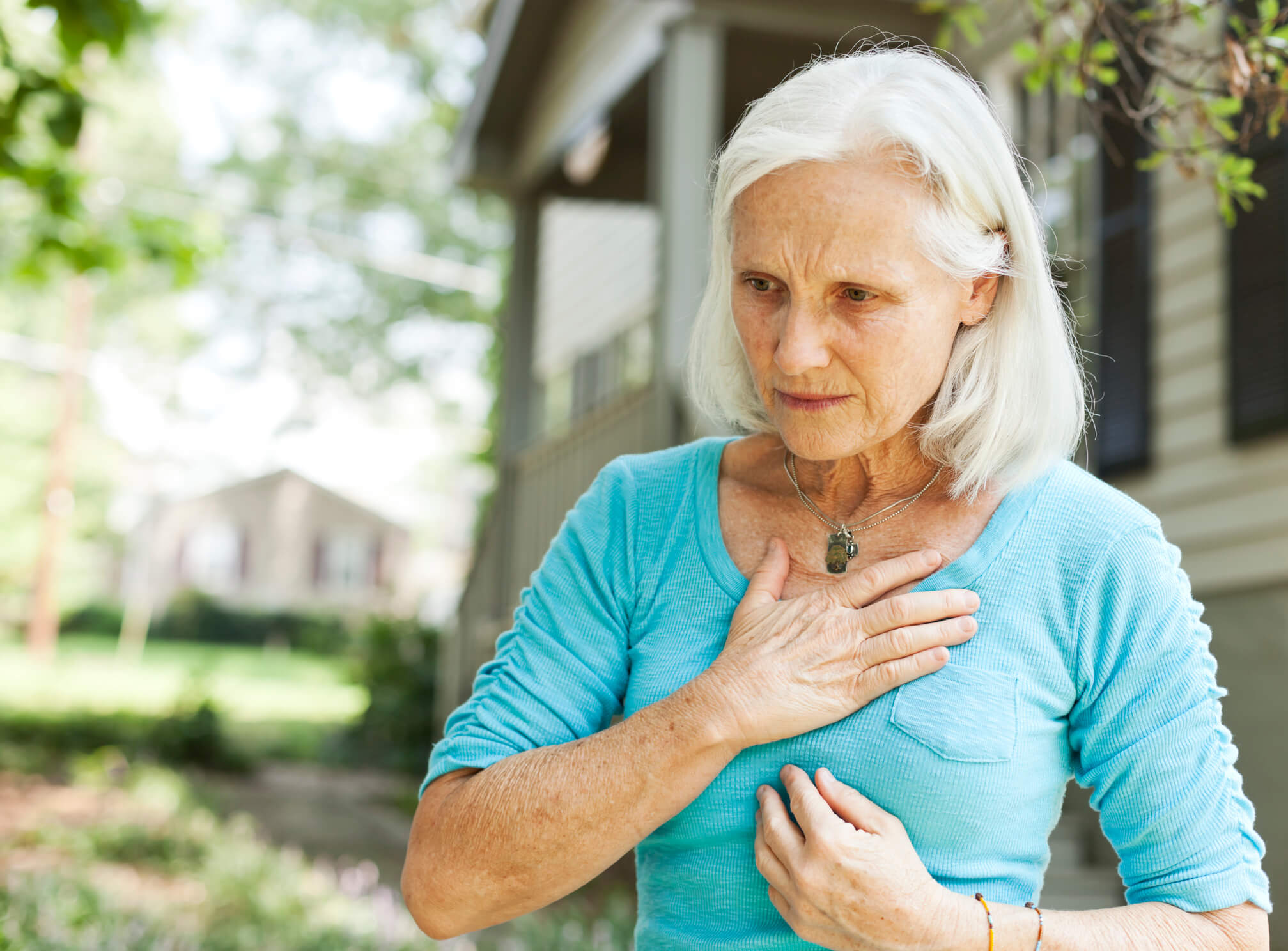 Older woman with hand over heart