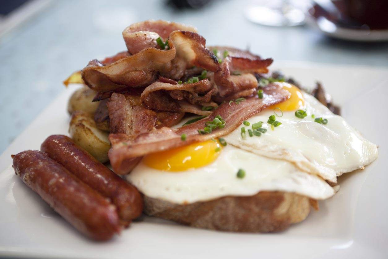 closeup of eggs, ham, bacon on toast