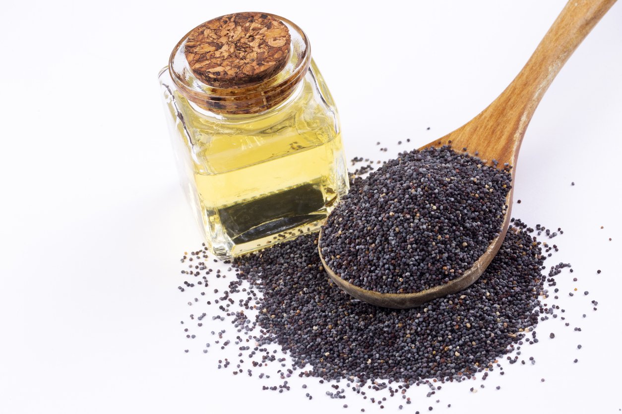 Poppy seeds with essential oil in a small jar