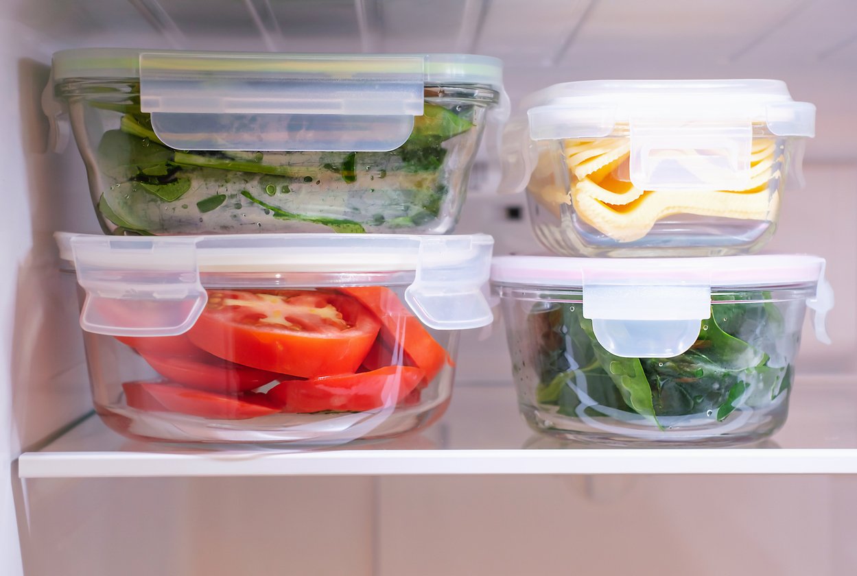 Vegetables in a glass boxes in the refrigerator close up.