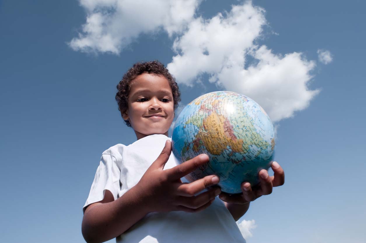 young boy holding globe