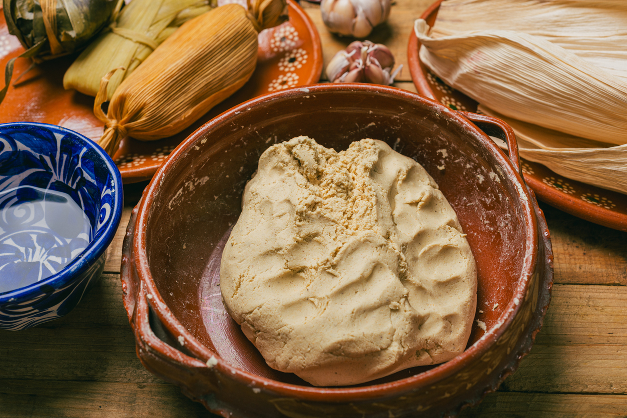 Corn dough nixtamalized in a clay pot to prepare tamales. Typical Mexican food.