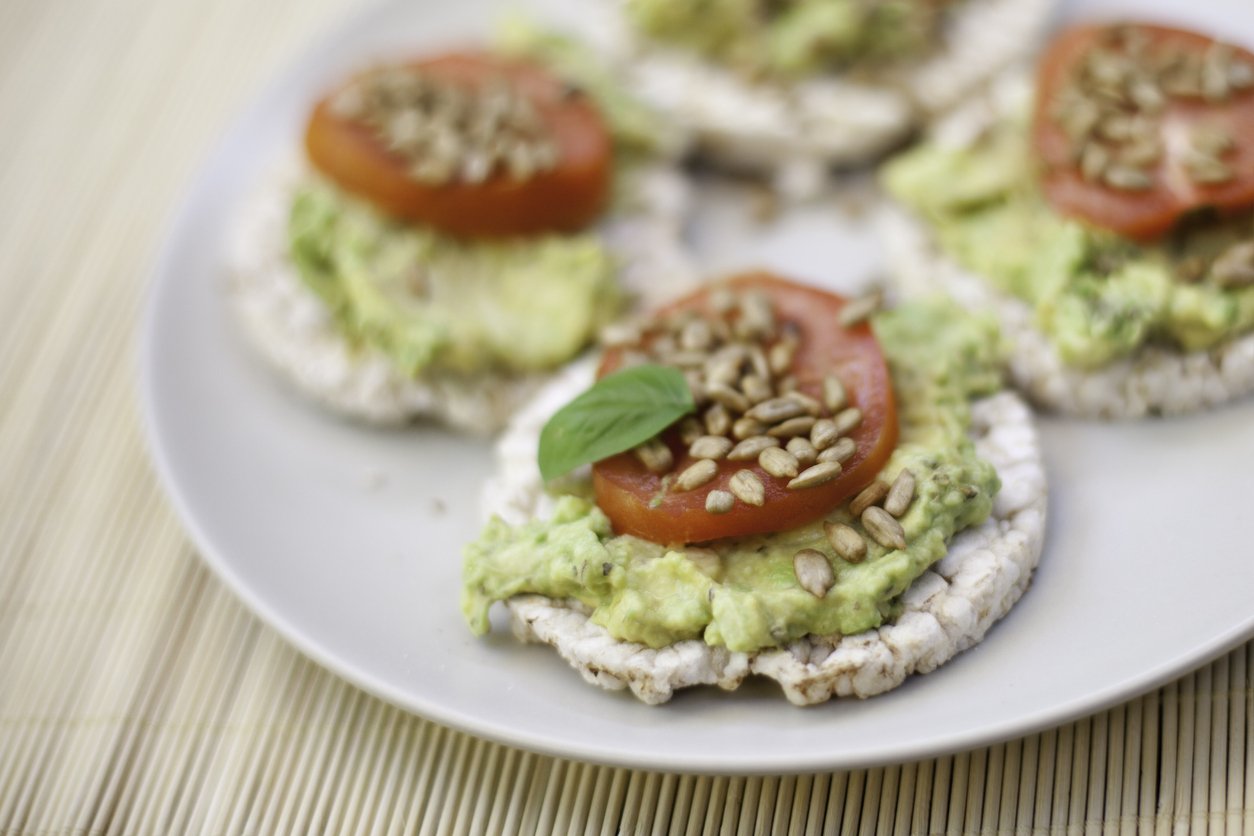 Guacamole, tomatoes on rice cakes.