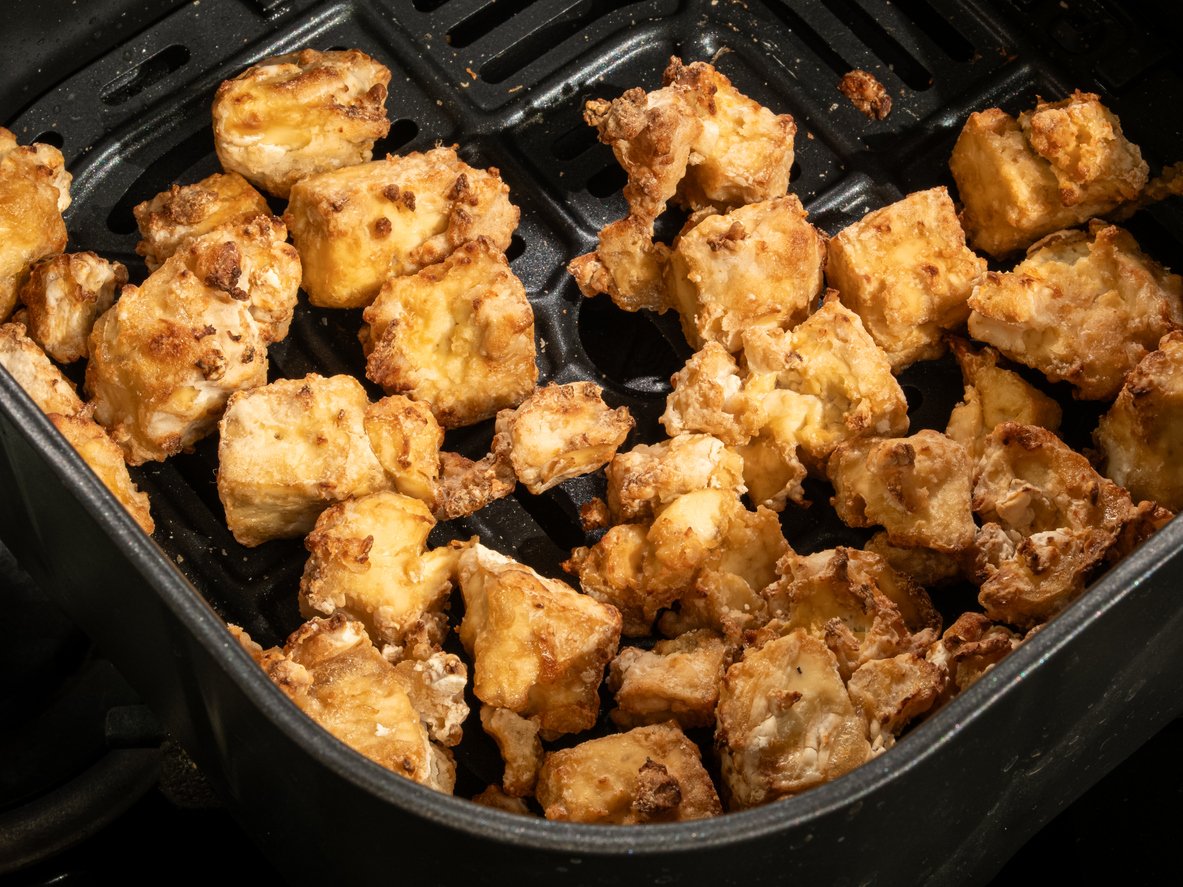 Detailed shot of golden and nutritious tofu cubes perfectly air-fried for a healthy culinary delight.