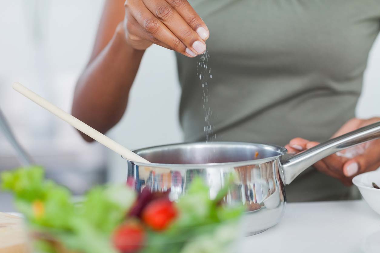 woman salting cooking