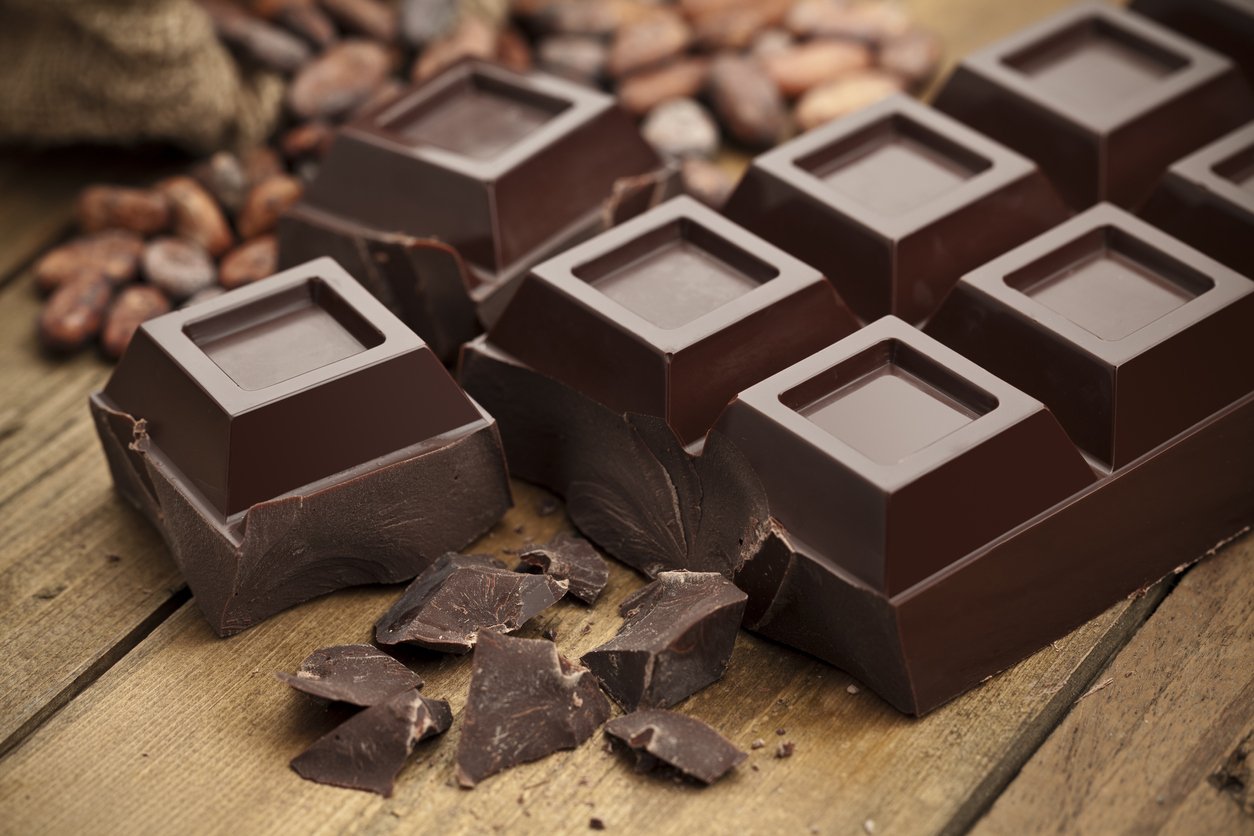 Dark chocolate bar on rustic wood table