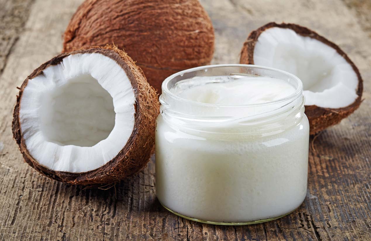 Fresh coconuts and jar of coconut oil, which is often a vegan substitution in baking