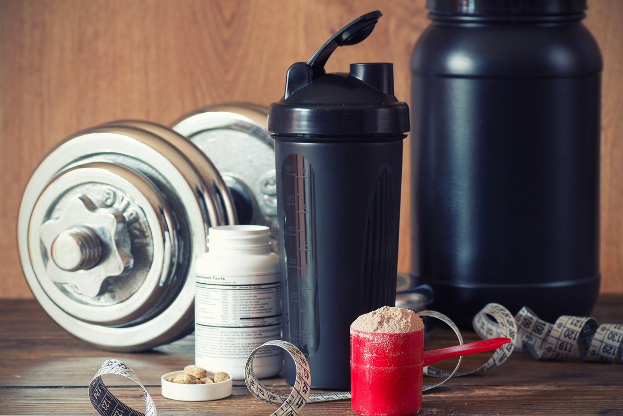 A variety of sports related supplement containers and athletic tools