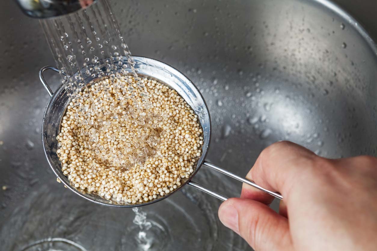 What is Quinoa? A seed and a grain. Rinsing quinoa in a strainer