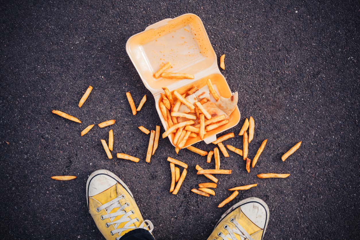 Dropped to-go container of French fries