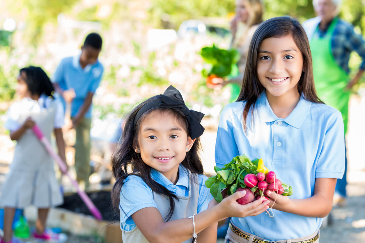 elementary girls touring garden during farm field trip