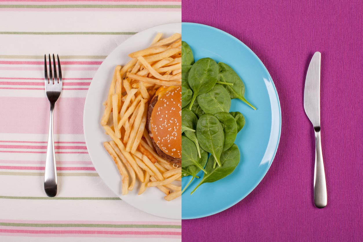 photo split in middle with burger and fries on one side, greens on other