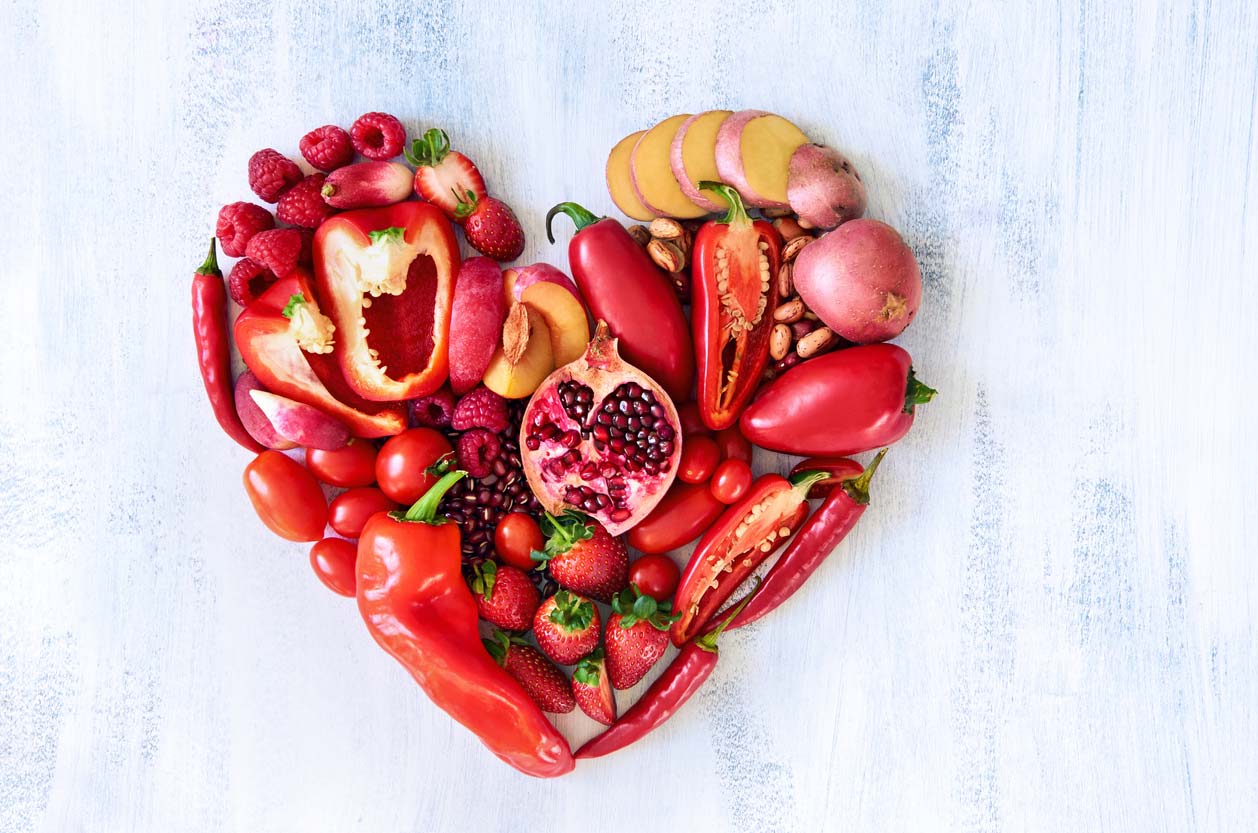 red heart made from red fruits and veggies