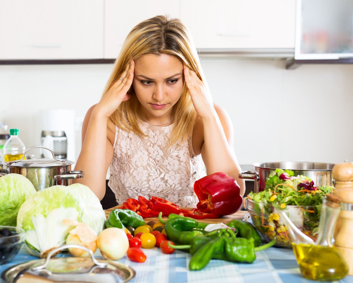 Depressed housewife thinking what to prepare for dinner