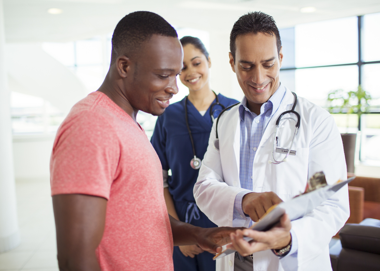 Doctor and patient reading medical chart in hospital